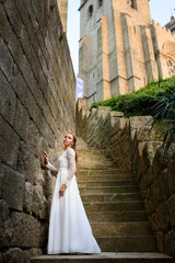 beautiful stylish bride near Church on the stairs