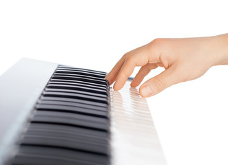 Fototapete - Hand and piano keyboard on white background