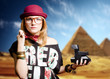 Pretty girl holding polaroid on sunny Egypt pyramid blurred background