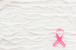 White fabric background with ruche. Pink ribbon - symbol of breast cancer awareness. Good as background for World Cancer Day posters, printed materials. Place for text.