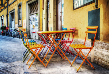 Wall Mural - colorful tables and chairs on the sidewalk in Florence