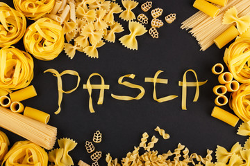 Word Pasta from pasta on the black background