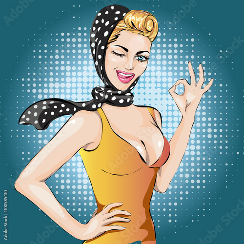 Plakat na zamówienie Pop Art winks woman with ok gesture . Pin-up girl.