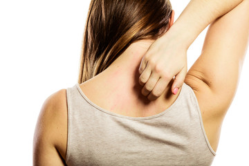 Woman scratching her back isolated