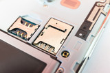 Fototapeta Miasta - Closeup slot SIM card and slot memory micro SD card for smartphone