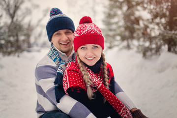 Wall Mural - Happy Young Couple in Winter Park having fun. Family Outdoors. l