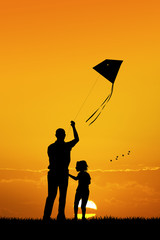 Wall Mural - father and son with kite at sunset