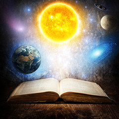 Wall Mural - opened magic book with sun, earth, moon, saturn, stars and galaxy. concept on the topic of astronomy