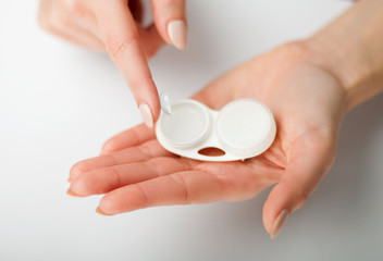 Wall Mural - Contact lens on finger with case