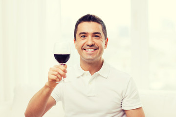 Poster - happy man drinking red wine from glass at home