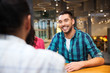 © Syda Productions - happy man meeting with friends at restaurant