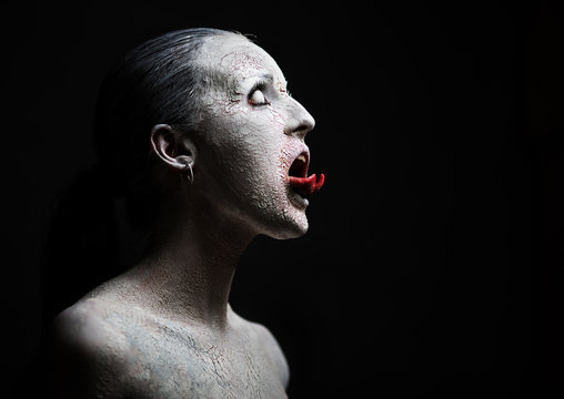 Fototapete - female demon.Art studio shot.Goth girl with sliced tongue