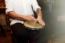 Stylish Percussionist Playing On Leather Drum On A Concert, Hand