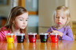 © MNStudio - Two little sisters painting colorful Easter eggs