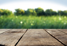 Wood Table And Green Grass Blurred Background