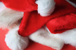 © nebari - Several Santa Claus hats tossed in a pile