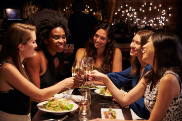 Group Of Female Friends Enjoying Meal In Restaurant