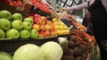 Woman Buys Vegetables At A Farm Market