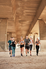 Wall Mural - Urban runners training under a bridge