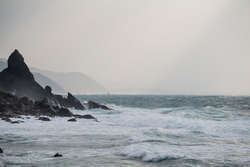 Wall Mural - Sea waves rolling on stones