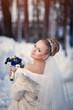 © EdNurg - bride posing in the winter forest in a fur coat. Wedding photo
