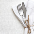 Knife and fork with white linen
