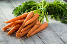 Fresh Carrots Bunch On Wooden Background