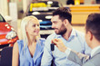 © Syda Productions - happy couple with car dealer in auto show or salon