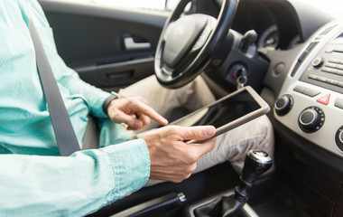 Sticker - close up of young man with tablet pc driving car