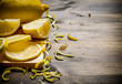 Cut the lemon zest on the Board. On wooden table.