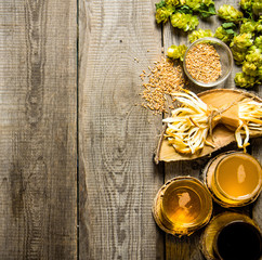 Poster - Fresh beer and the salty cheese on a wooden table.