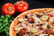 © smspsy - closeup Tasty pizza with tomatoes, cheese, basil and ham on a bl