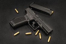 Handgun On The Black Background