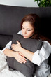 © Gelpi - Relaxed young girl hugging a cushion