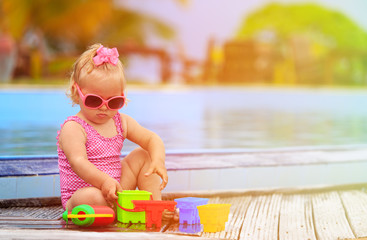 Wall Mural - cute little girl playing in swimming pool at beach