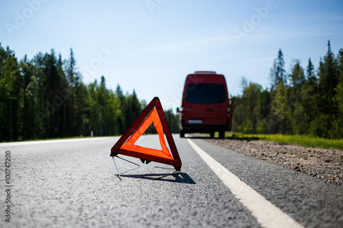 Fotografie, Obraz Red warning triangle with a broken down minibus car
