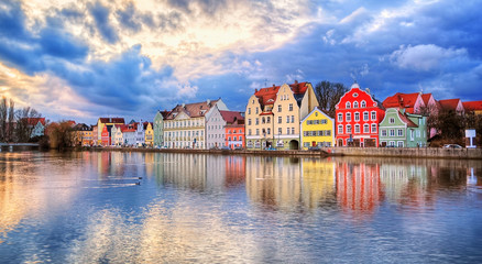 colorful gothic houses reflecting in isar river on sunset, landshut, germany