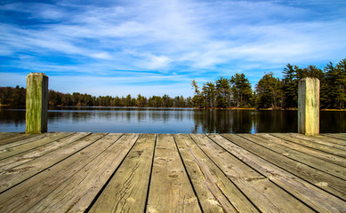 summer day at the lake. wooden dock overlooking a gorgeous lake in the wilderness. ludington state p