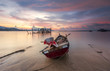 Fisherman boats at Black Sand Beach Village in Langkawi, Malaysia in sunset