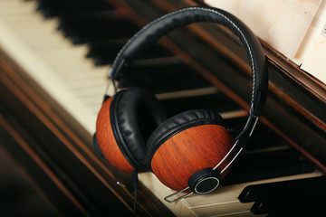 Wall Mural - Brown headphones on piano keyboard, close up