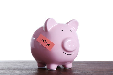 Poster - Piggy bank with money for college, on wooden table, on white background