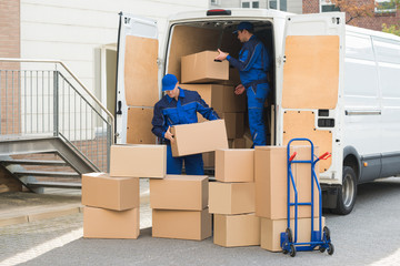 Delivery Men Unloading Boxes On Street