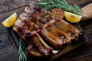 Wall Mural - Closeup of baked pork ribs with lemon, garlic and rosemary