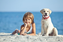Happy Kid With A Dog On The Beach 