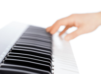 Fototapete - Hand and piano keyboard on white background
