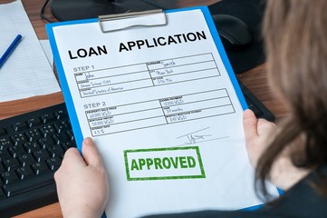 Loan application form with approved stamp.