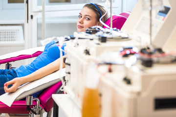 Pretty, young woman giving blood/plasma