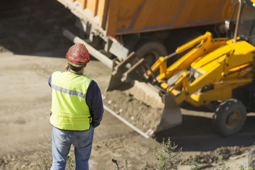 engineer foreman in highway construction site with excavators selective focus 