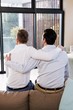 © WavebreakMediaMicro - Rear view of gay couple with arms around