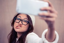 Asian Woman Making Faces And Taking Selfie